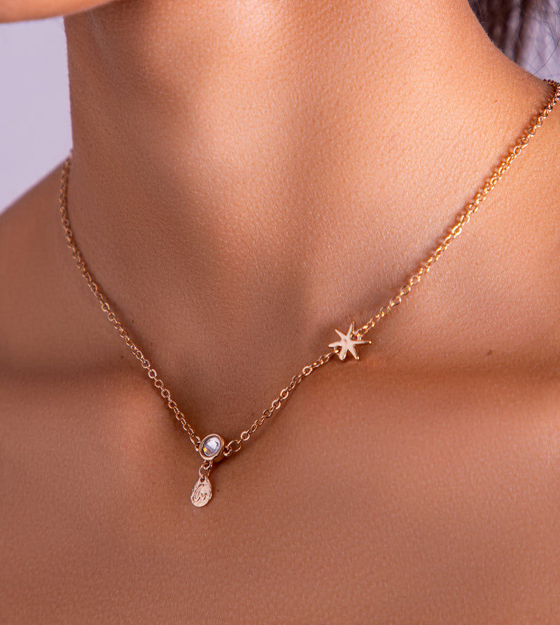 Star pendant with golden charms and an adjustable chain